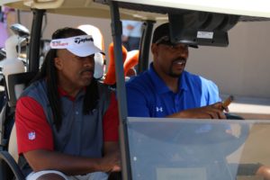 golfers in cart | charity golf classic 2016