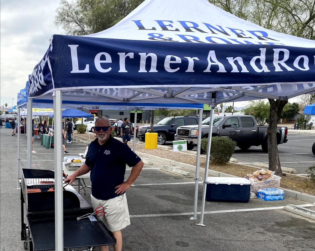 Lerner and Rowe serving hot dogs at a Las Vegas United Community event 