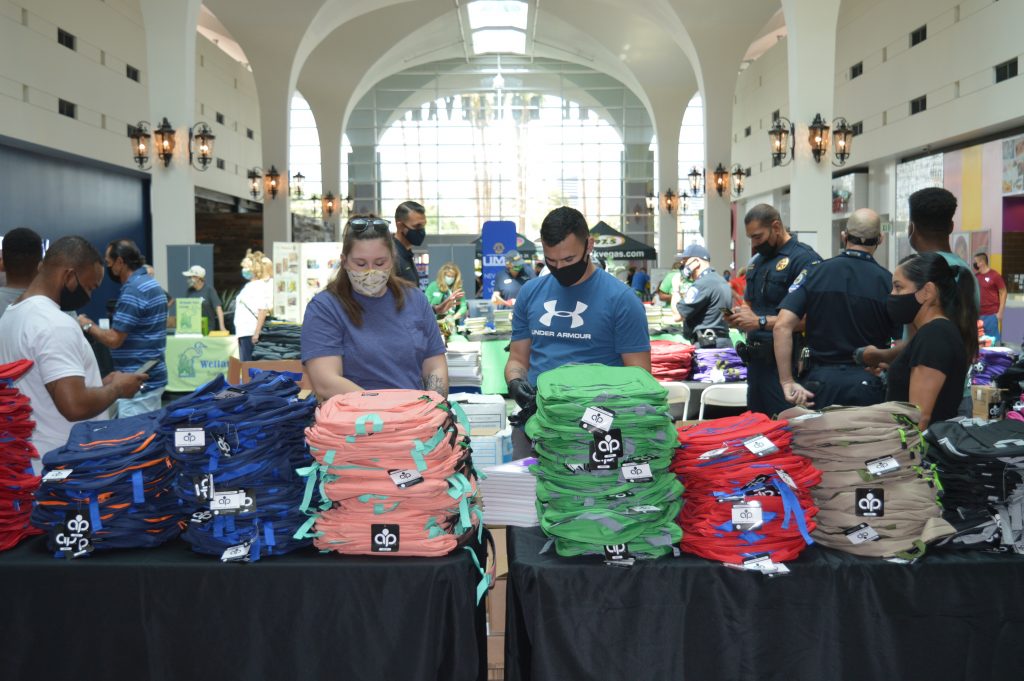 Table of backpacks donated by Lerner and Rowe Gives Back