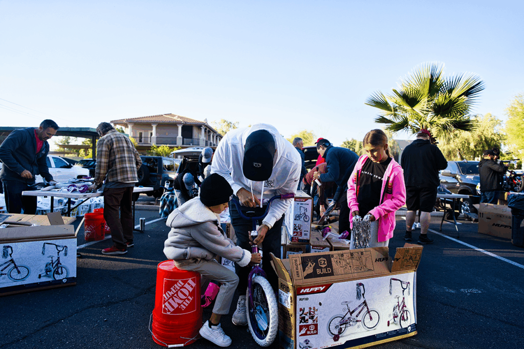 Kevin Rowe and kids assembling a bike 2025